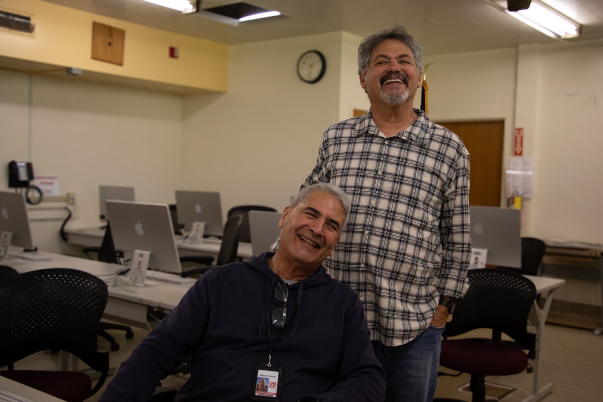 Bill (sitting) and Steve Espinosa show all smiles in the photography lab on Feb. 13 at City College's Wake Campus in Santa Barbara, Calif. The retired first responder and veteran host a digital photography class designated for retired veterans, first responders, and their spouses with photo equipment provided by Canon USA. 
