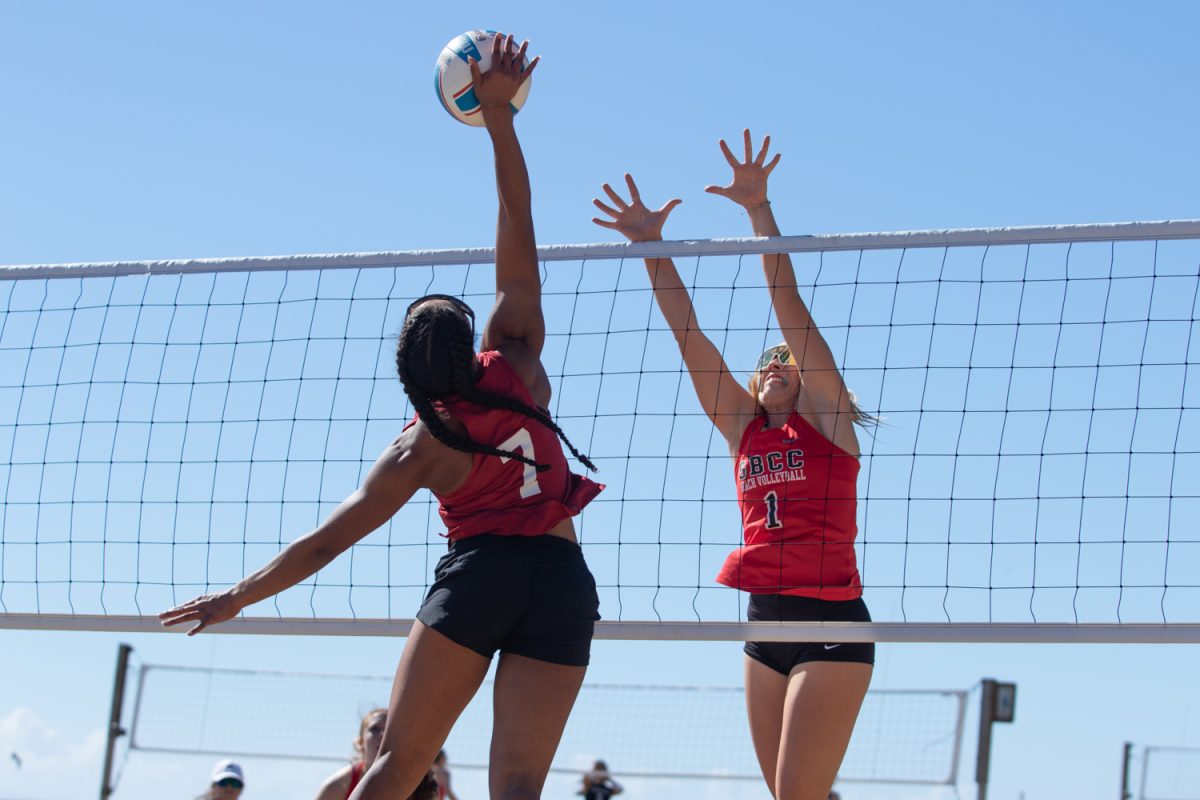 Olivia Medina, No. 1, attempts to block Alexis Abedoduns, No. 7, spike over the net during their match on Feb. 2 at East Beach in Santa Barbara, Calif. To prepare for a spike, the two players have two places on the court to be, in front to block the hit and in the back prepared to dive for the ball.