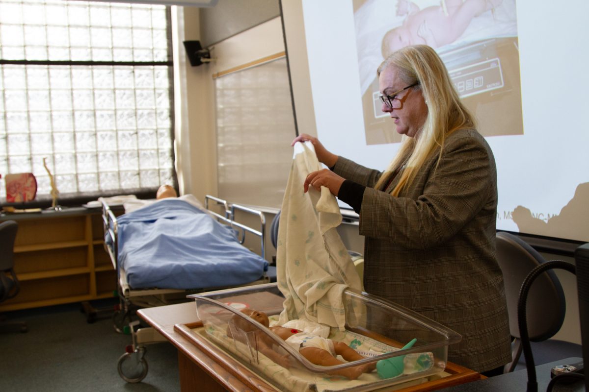 Mary Sullivan, associate degree nursing program director, demonstrates the proper technique for swaddling an infant on March 1 at City College in Santa Barbara, Calif. Sullivan teaches a Maternal Newborn and Pediatric Nursing class on Friday mornings.
