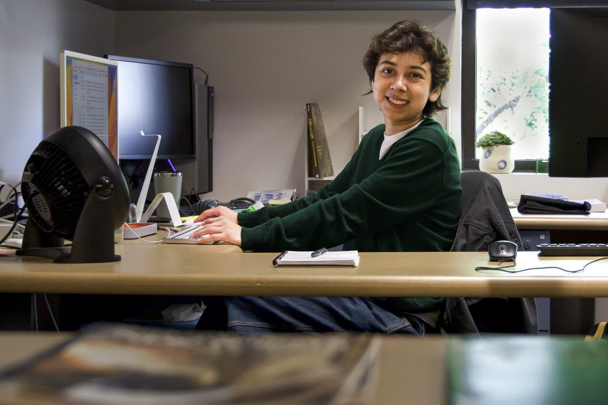 Abril Orozco glances over from their desk in the DAC Lab on March 21 at City College campus in Santa Barbara, Calif. I see myself as an intermediary, where I help faculty... and connect with the students and see what they need Orozco said.