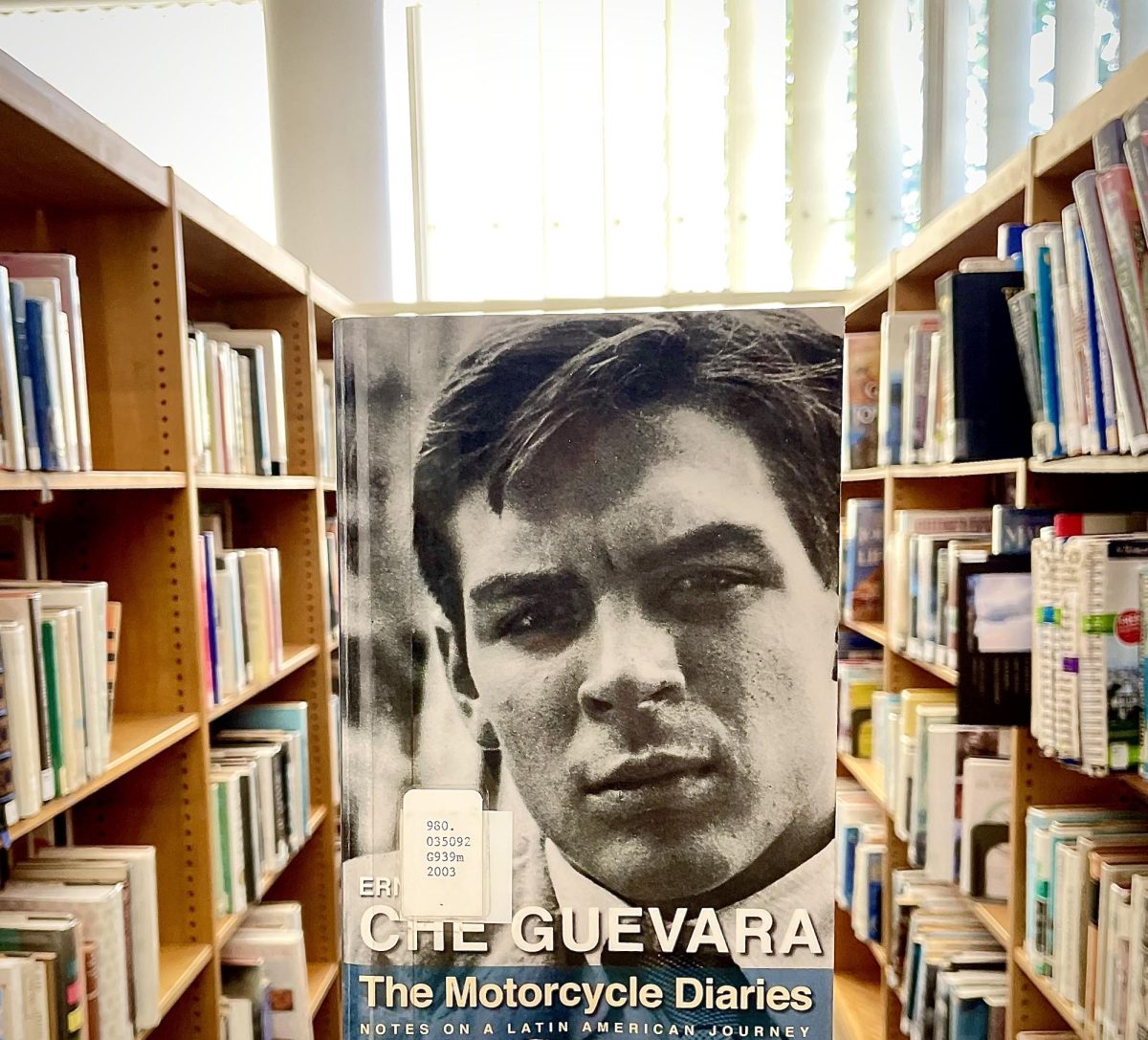 A library copy of The Motorcycle Diaries, by Ernesto (Che) Guevara, held up between rows of books, on March 3 inside of E.P. Foster Library in Ventura, Calif.