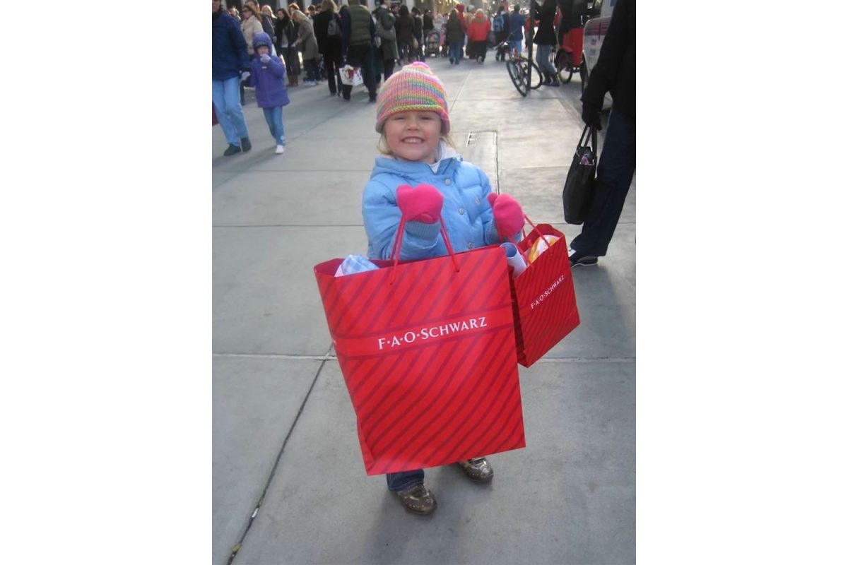 Brenda Greening proudly clutching her newly purchased bags of barbies in 2007, in New York City, New York. Courtesy of Brenda Greening.