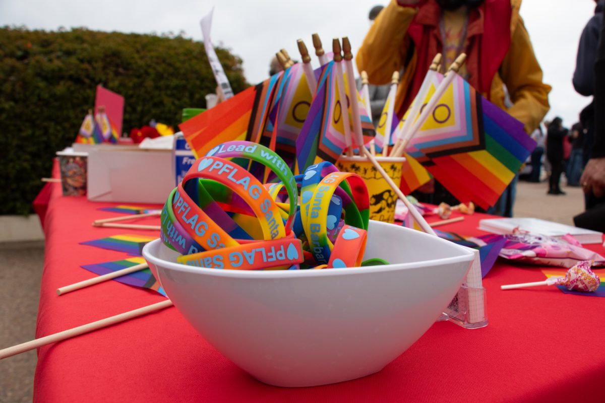 PFLAG Santa Barbara bracelets and mini gay pride flags are up for grabs during the first ever pride flag raising ceremony on April 4 at City College in Santa Barbara, Calif. PFLAG is a band of friends, family and members of the LGBTQ+ community founded in 1973.
