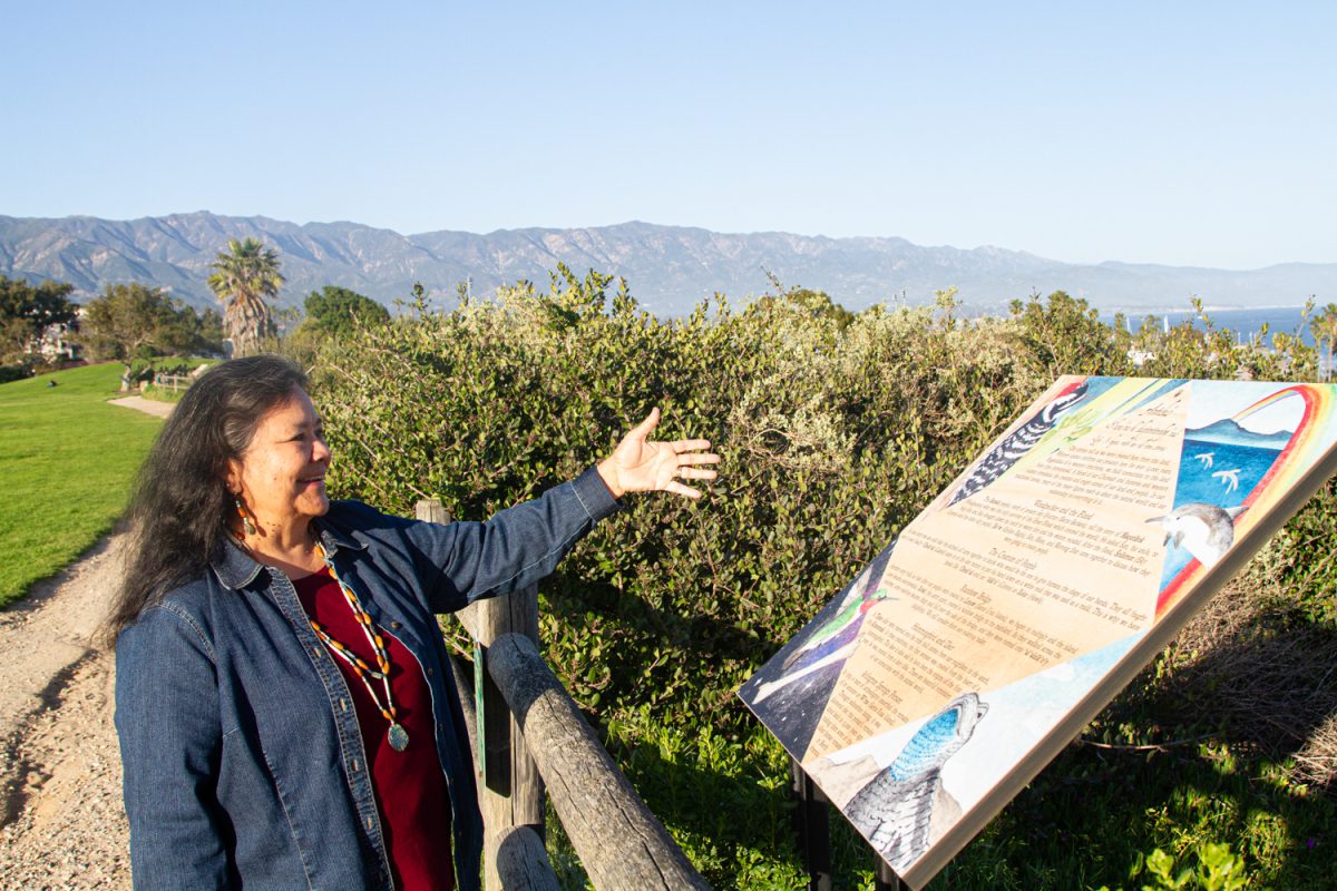 Annette Cordero, retired English professor and member of the Coastal Band of the Chumash Nation motions towards one of eight newly installed Chumash history signs, surrounding the great meadow on April 8 at City College in Santa Barbara, Calif. Cordero explains the cultural significance of four traditional Chumash stories centered around the origins of their people.