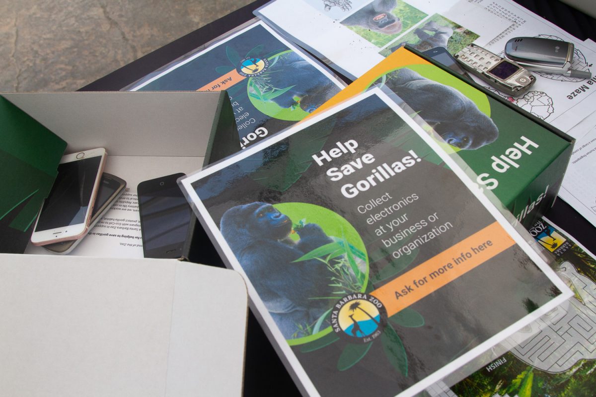 The Zoo sets up a stand to inform attendees about how they are continuously collecting phones in order to stop gorilla habitat disruption on April 21 at the Santa Barbara Zoo. "The material used to help phones work, or coltan, is mined in Gorilla habitats," zoo volunteer Ariel Muniez said. 