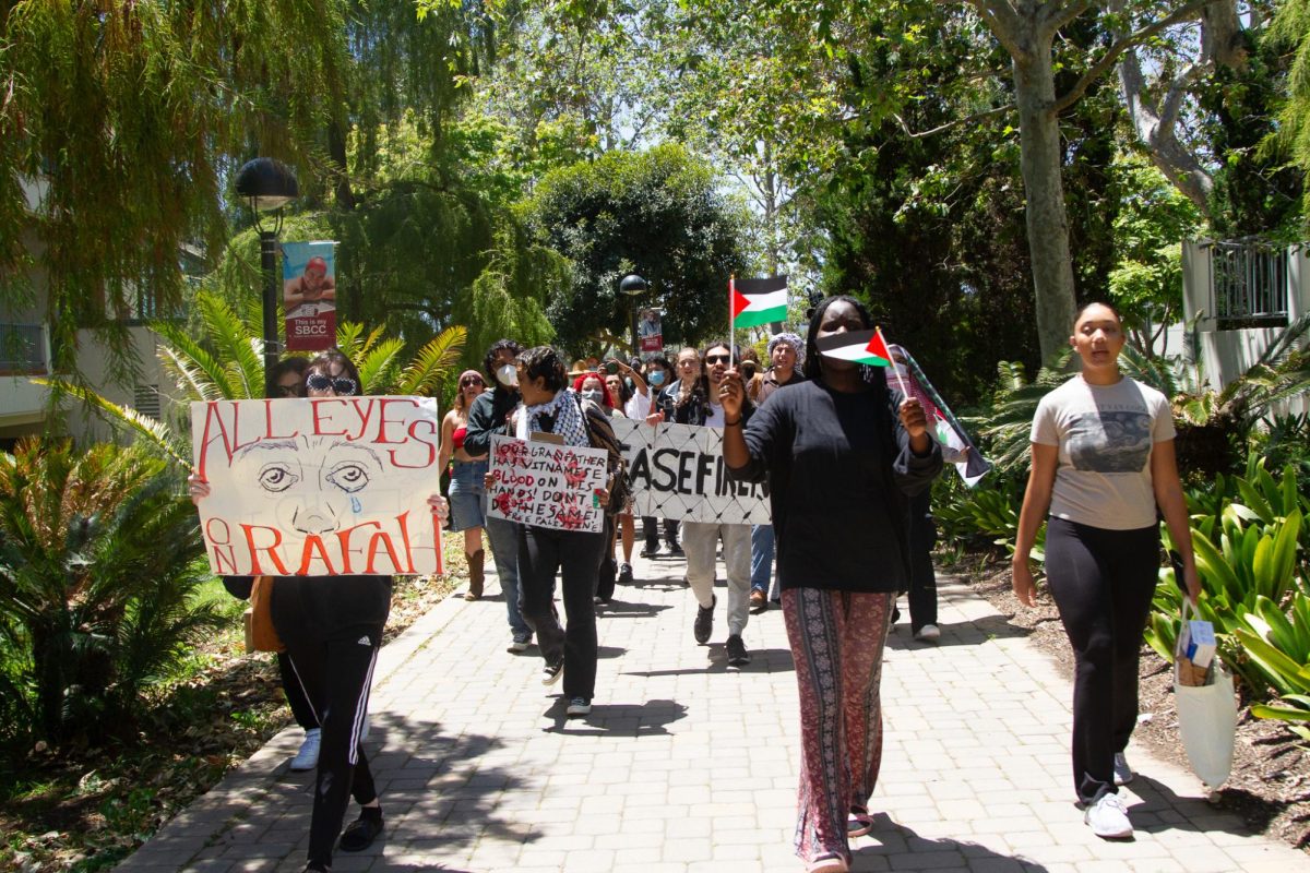 Members of the March for Palestine protest walk towards the City Colleges East Campus Cafeteria on May 7 in Santa Barbara, Calif. Protestors are determined for their voices to be heard at City College.