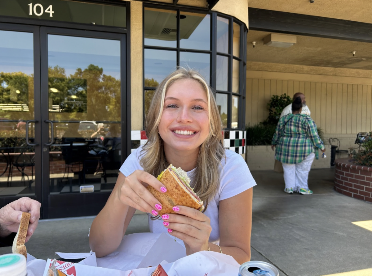 Anika Brodnansky ecstatically holds her favorite sandwich from Podesto’s in Stockton, Calif. She always orders it on a wheat roll with a side of Doritos. 