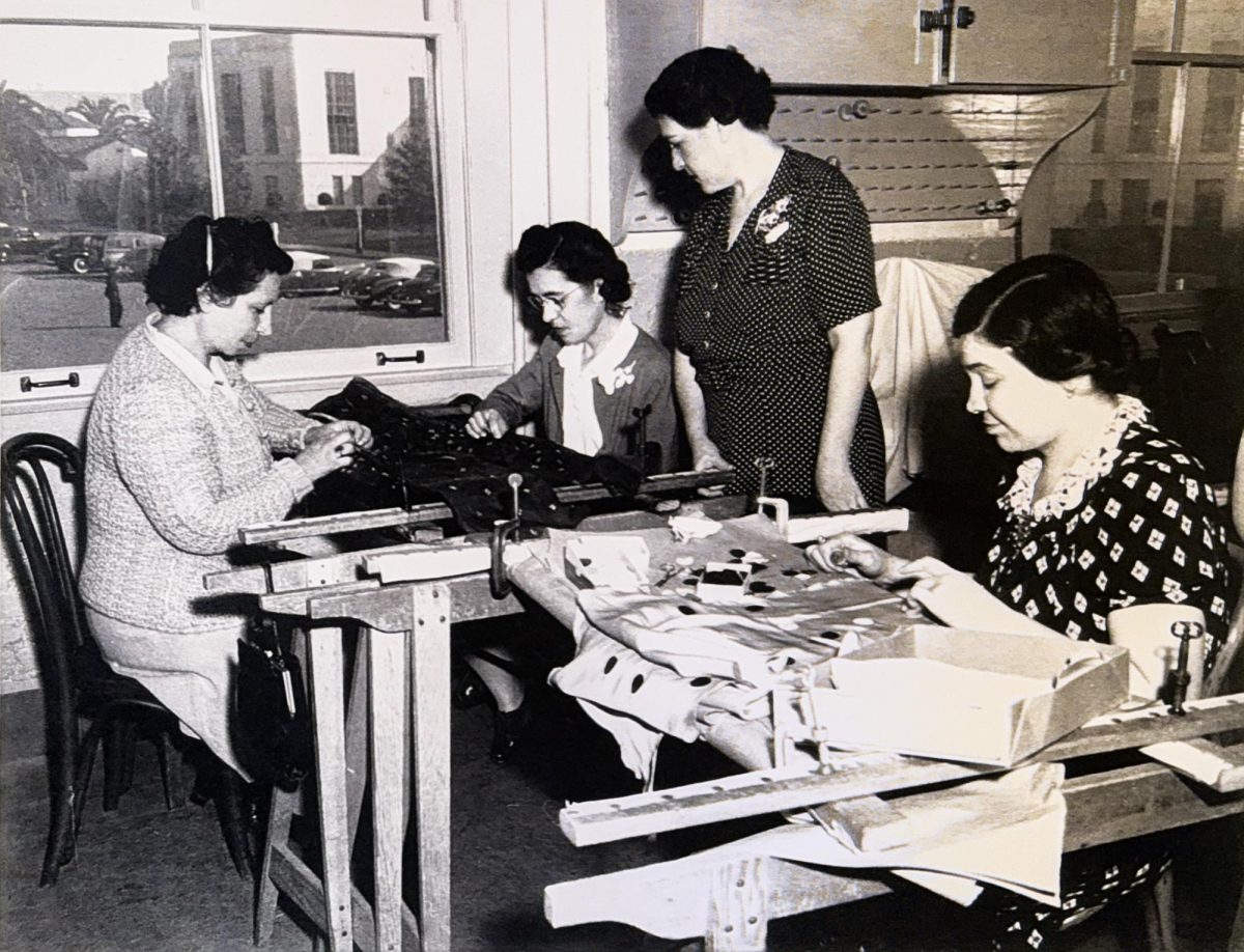 Sara Lozano (standing) oversees employees on a production of a dress in 1939 at Metro-Goldwyn-Mayer (MGM) studio. Image is a family file photo. 