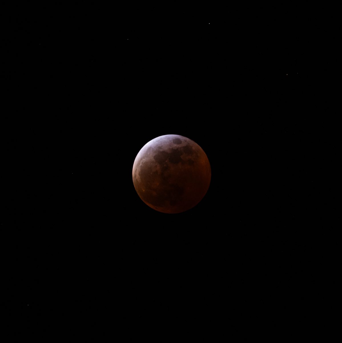 The moon shines red after being engulfed by Earth's shadow March 13 as seen from Mission Rose Garden in Santa Barbara, Calif. Beginning at roughly 11:26 p.m., the totality phase continued into the early hours of Friday morning.