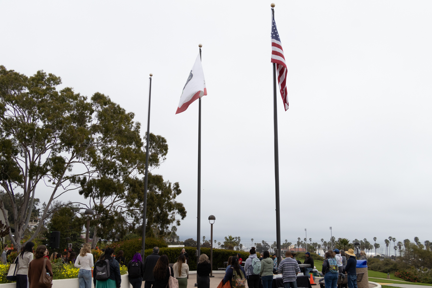Students and faculty gather around the front of City College's Luria Library March 31 in Santa Barbara, Calif. The SBCC flag was taken down in anticipation for the flag raising event.
