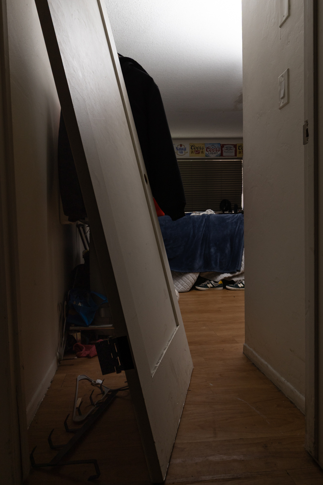 The unhinged door to the room shared by Nico Kemp and his two roommates sits against the wall April 19 at Beach City apartment complex in Santa Barbara, Calif. The door was previously kicked down during a party.