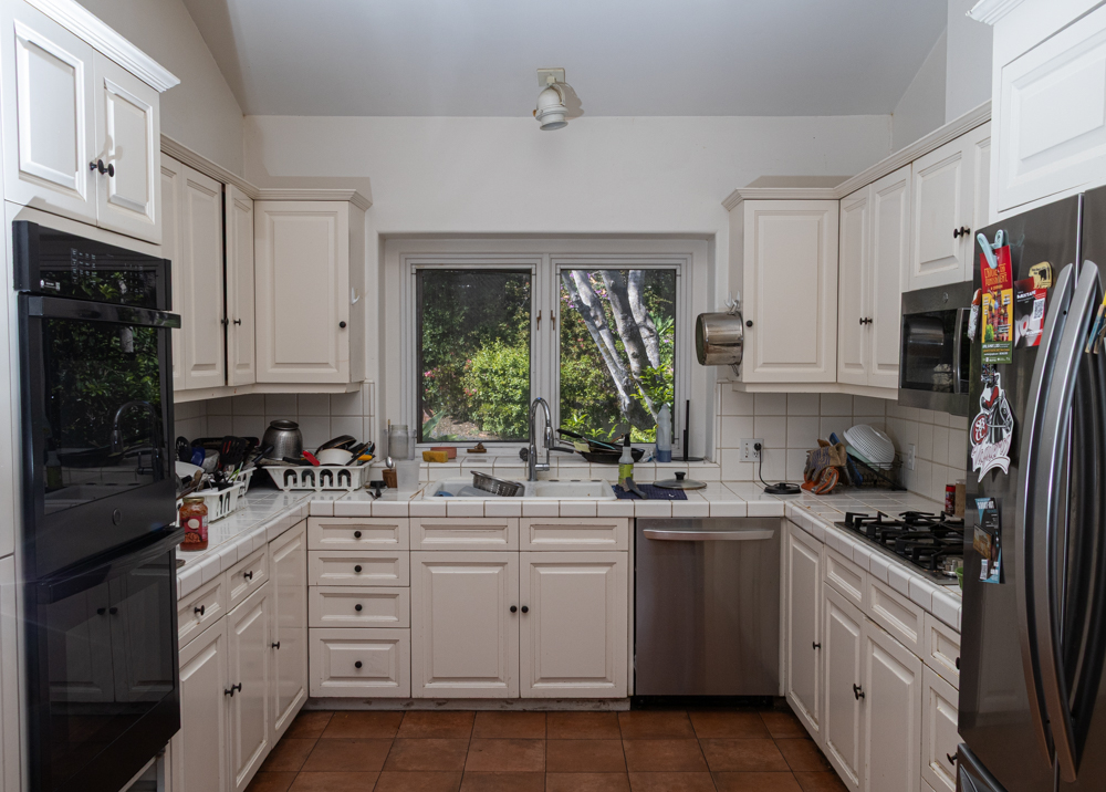 Shared by 25 residents, the Arroyo House kitchen shows signs of use April 28 in Santa Barbara, Calif. With high occupancy, the area is a constant struggle to keep clean.
