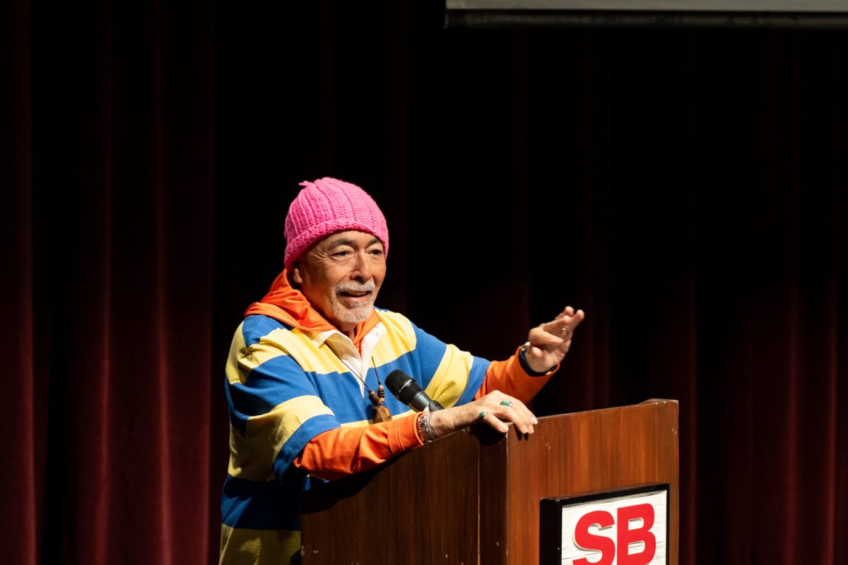 On April 2 Juan Felipe Herrera served as the speaker for the poetry workshop "The Creative Process of Writing Poetry" at the Garvin Theatre at City College in Santa Barbara, Calif. In the photo, he is seen standing alone at the podium, deeply engaged in sharing his creative insights with the attendees. The event attracted many aspiring poets and literature enthusiasts who gathered to explore the art of poetry writing.