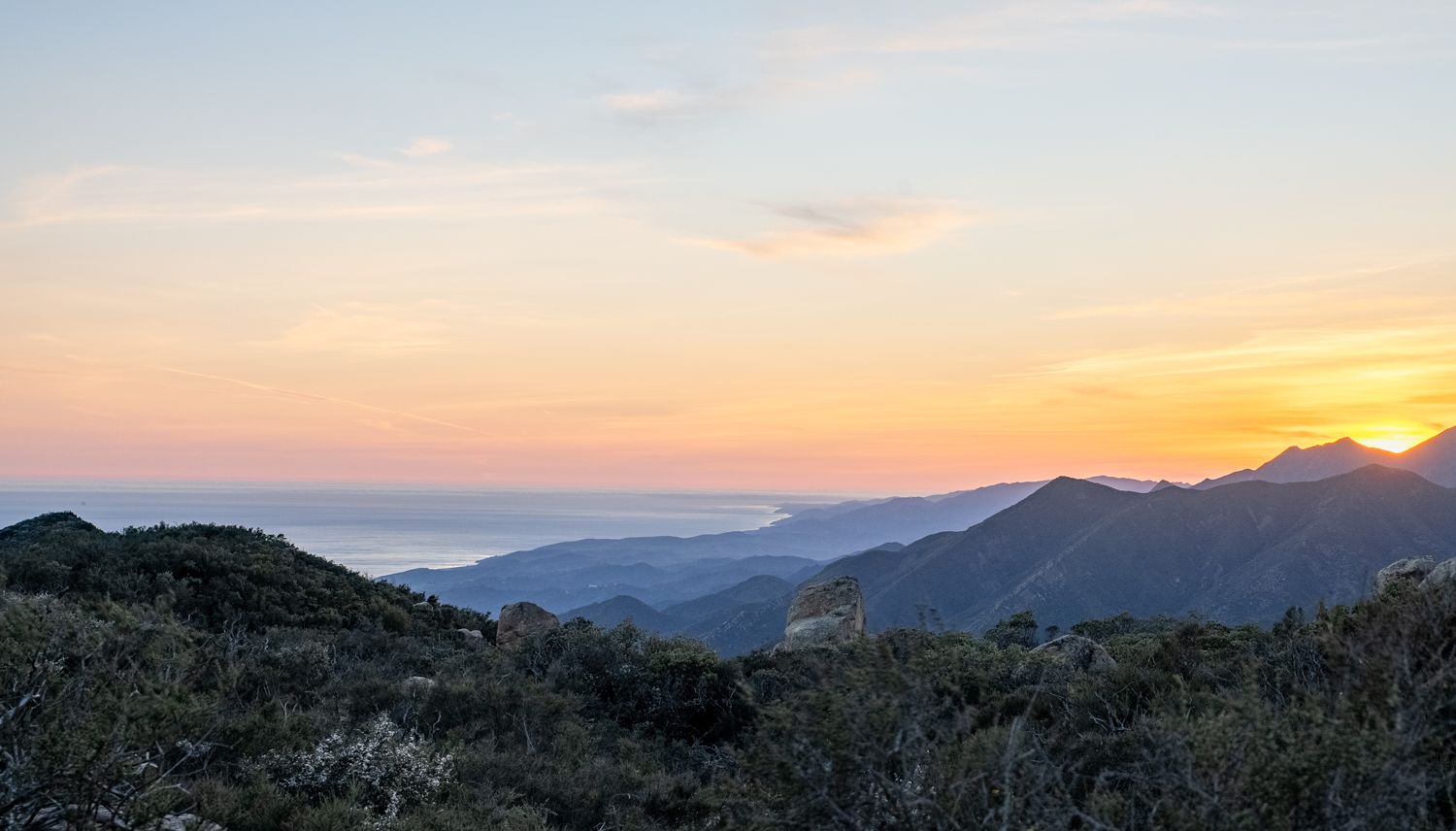 This high dynamic range photograph combines six images shot from the same position and composited together to capture the Santa Ynez Mountains to the North of downtown Santa Barbara. The vast expanse of mountains and the Pacific Ocean meet in the distance, with the sky illuminated in red hues above the landscape on April 7 in Santa Barbara, Calif. 