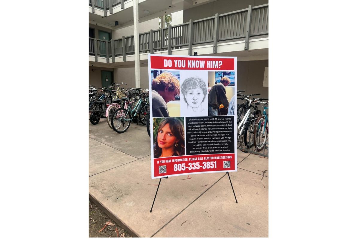 A modified banner sits at a press conference at UCSB's San Rafael Dorms on May 1 in Isla Vista, Santa Barbara. The image of the believed person of interest shown on this banner has been  doctored to remove Elizabeth Hamel for privacy reasons, according to private investigator Tyrone Maho.