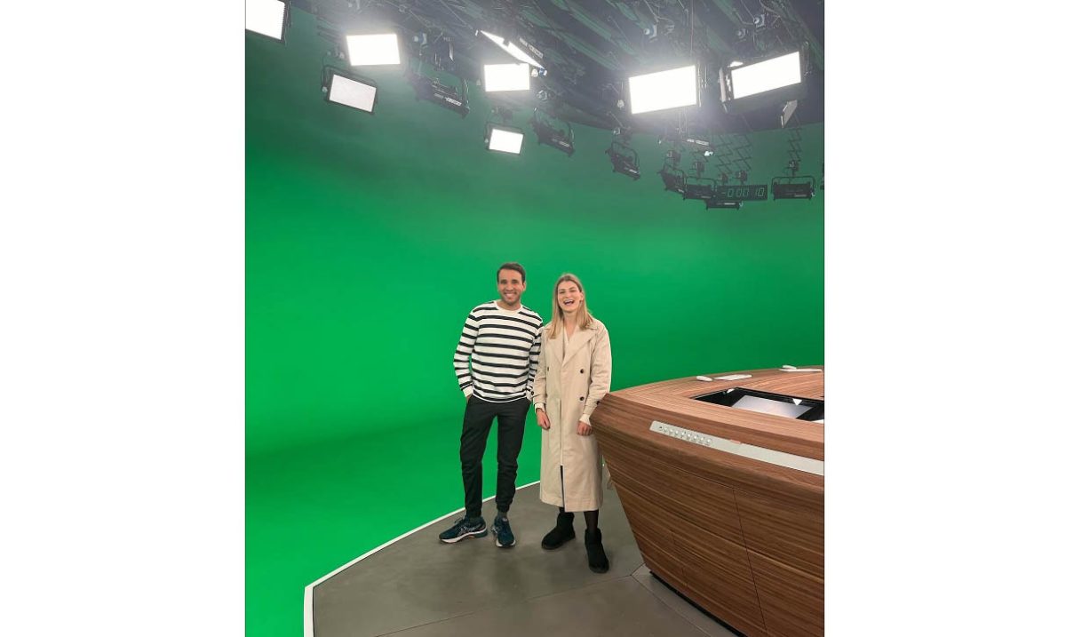Julia Catharina-Schmidt smiles in front of the green screen after finishing high school. Catharina-Schmidt worked at an internship after graduating high school.