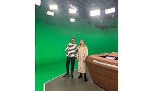 Julia Catharina-Schmidt smiles in front of the green screen after finishing high school. Catharina-Schmidt worked at an internship after graduating high school.
