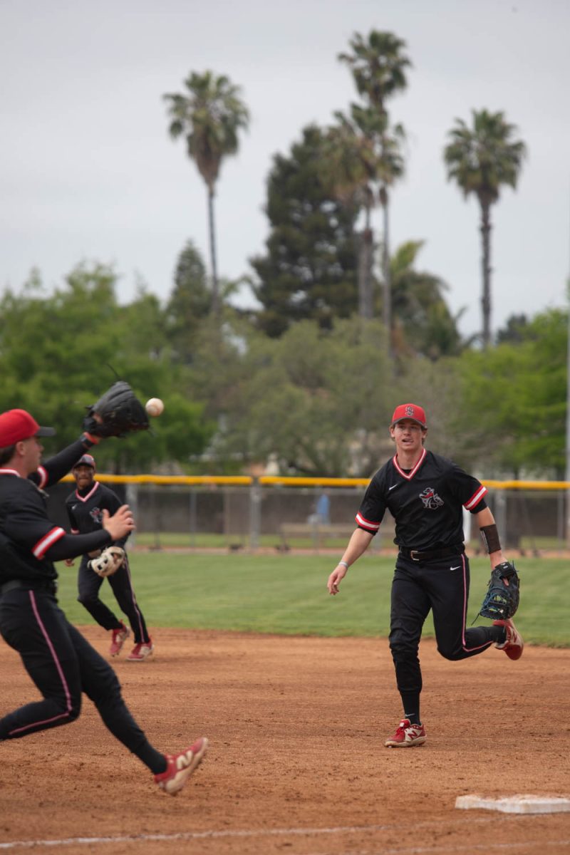 Sean Asperger throws a hit ball to pitcher Joseph Talarico covering first base to get the runner out on May 2 at Pershing Park in Santa Barbara, Calif. The two players successfully got the runner out, bringing them closer to the end of the inning.