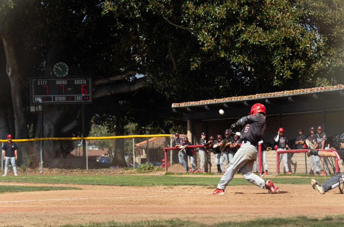 Wyatt La Marsna (No. 5) drives the ball into the outfield April 12 at City College's Pershing Park in Santa Barbara, Calif. Marsna would later give Pierce College the lead in the seventh inning.