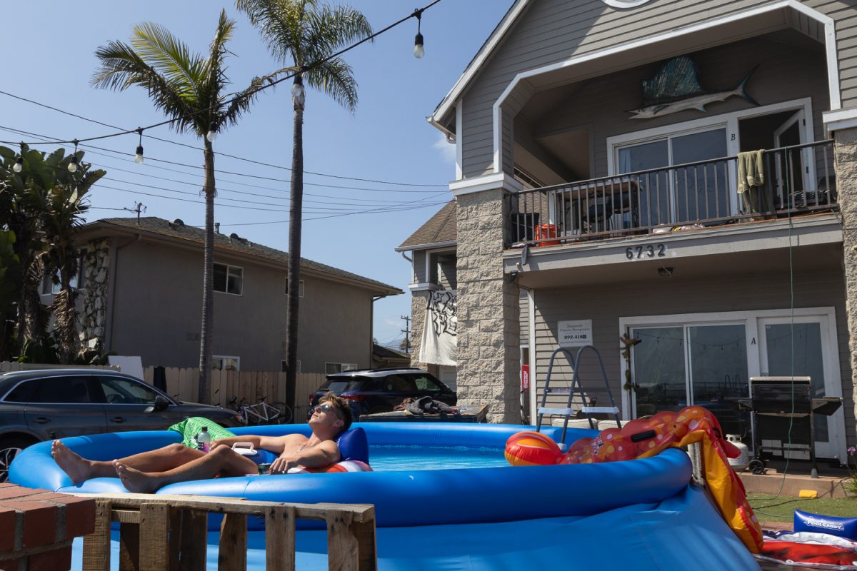 Pre-law student JJ relaxes in an above ground swimming pool in his front yard. May 4 in Isla Vista, Calif. "I play on a sports team and the boys—the seniors offered to give us their house, passing down the lease," he said. "We didn't have to search at all."